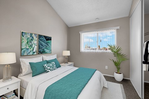 A bedroom with a large bed and a painting on the wall.