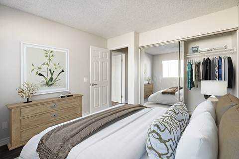 A bedroom with a bed, dresser, and a painting of a plant.