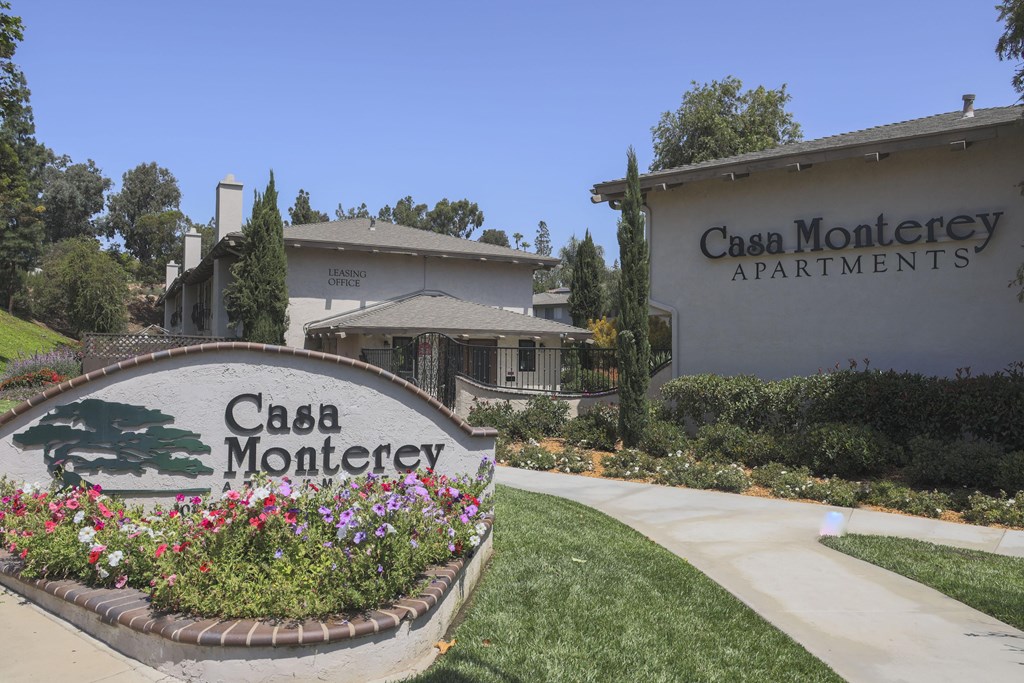 A sign for Casa Monterey Apartments is in front of a building.