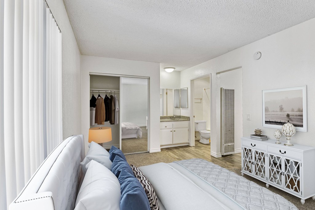A white living room with a couch and a mirror.