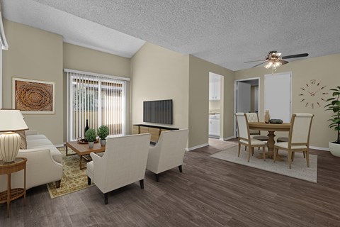 A living room with a white couch, a wooden coffee table, and a ceiling fan.
