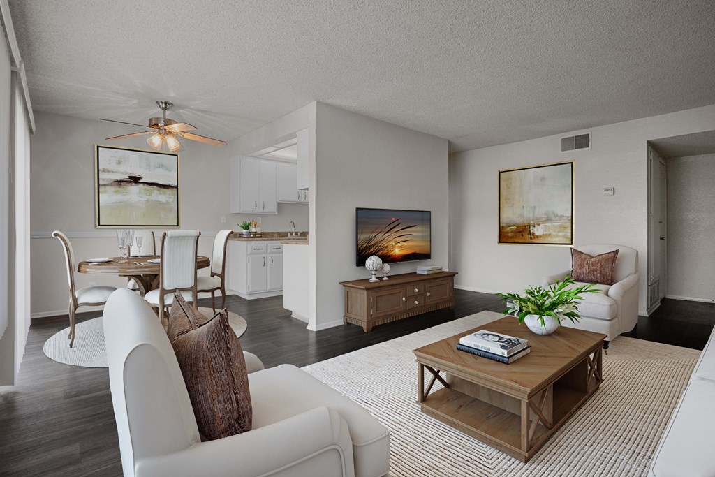 A living room with a white couch and a wooden coffee table.
