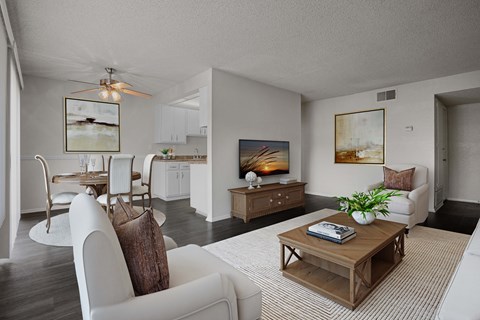 A living room with a white couch and a wooden coffee table.
