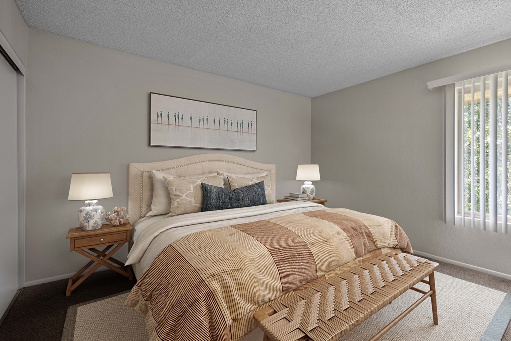 A bedroom with a bed, nightstands, and a bench.