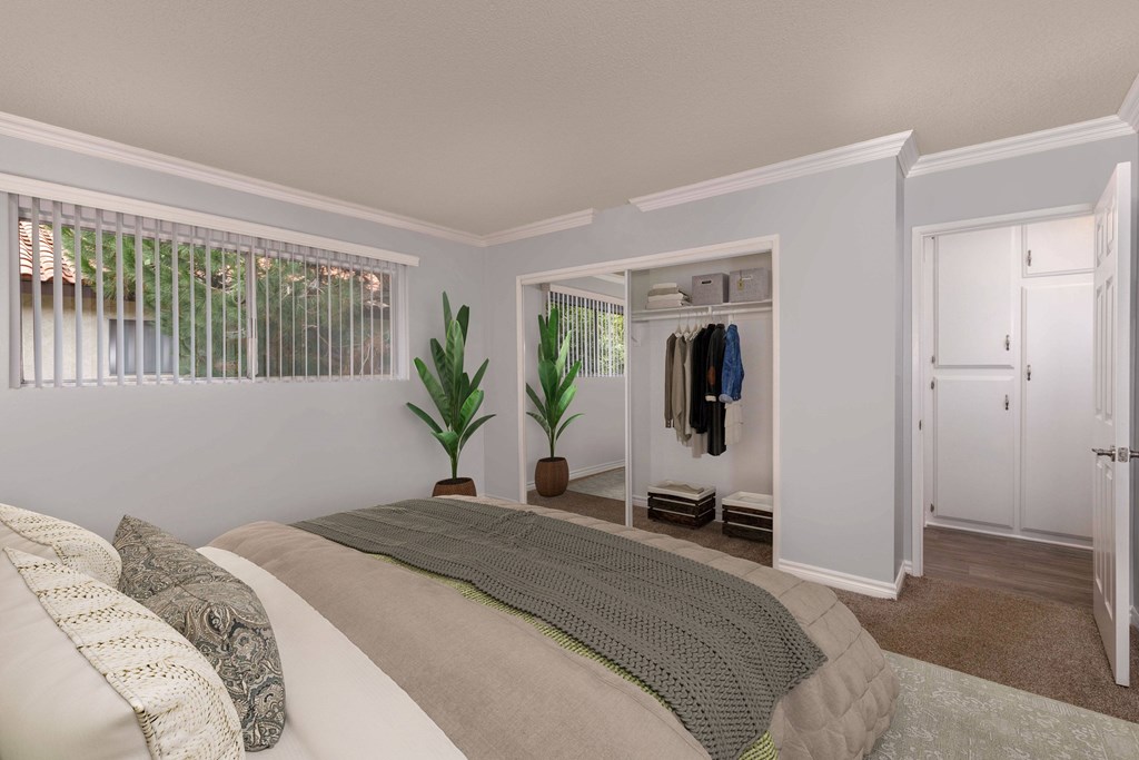 A bedroom with a bed, pillows, a window, a coat rack, and a plant.