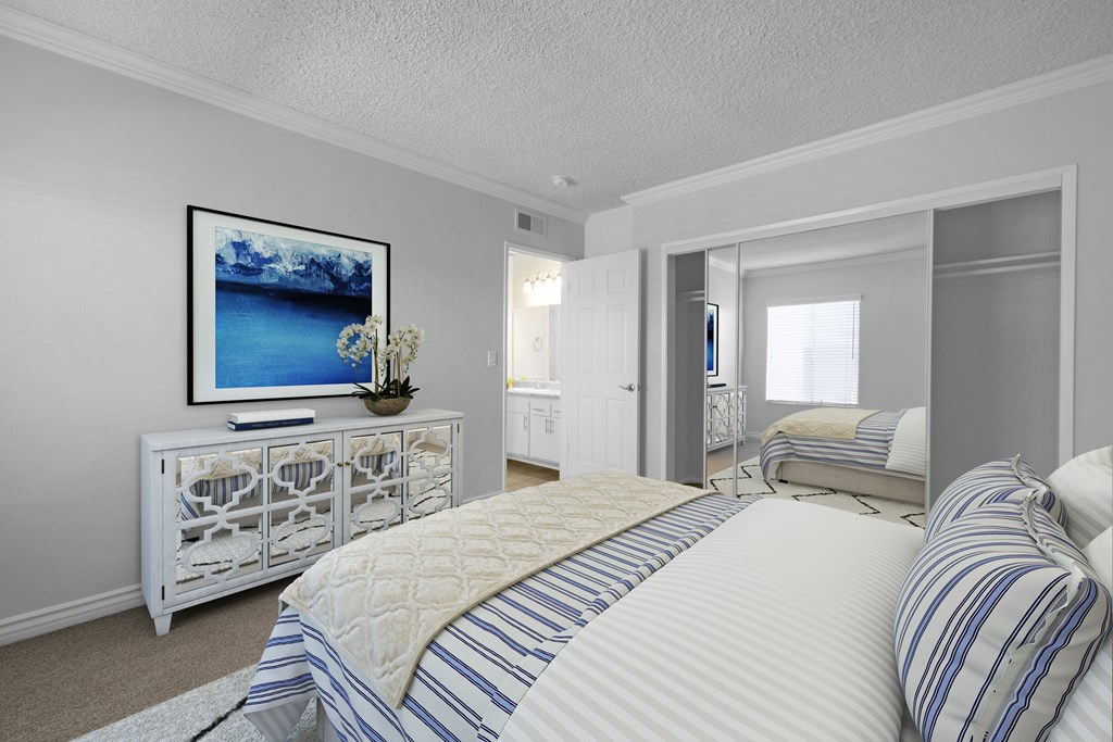 A bedroom with a large bed and a painting on the wall.