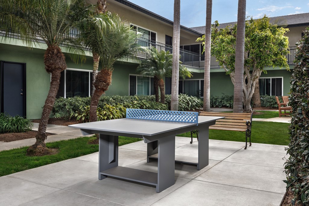 A grey table with a blue and white table cloth on it.