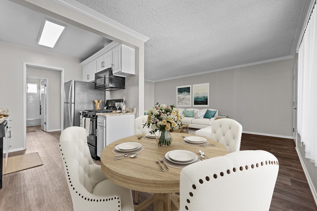 A modern kitchen with a dining table set for four.