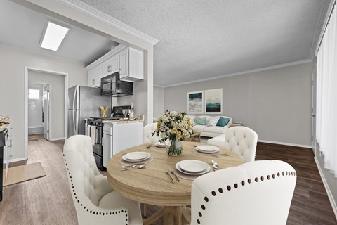 A modern kitchen with a dining table set for two.