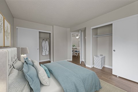 A bedroom with a bed and a lamp.