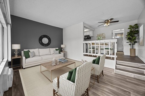 A living room with a white couch and a wooden coffee table.