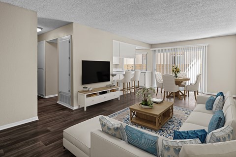 A living room with a white couch and a wooden coffee table.