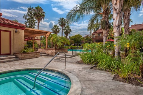 A pool with a slide in the middle of a backyard.