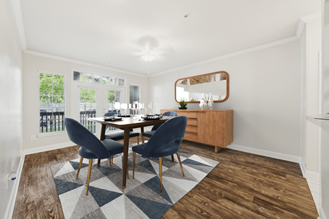 A dining room with a table and chairs.