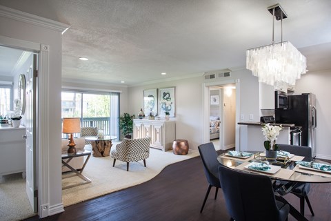 A modern dining room with a large table and chairs.