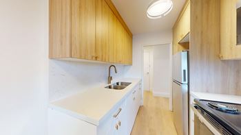A kitchen with wooden cabinets and stainless steel appliances.