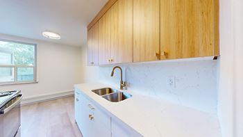 A kitchen with wooden cabinets and a white countertop.