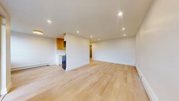 A room with wooden floors and white walls.