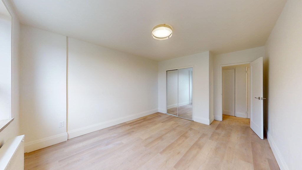 A room with wooden floors and white walls.