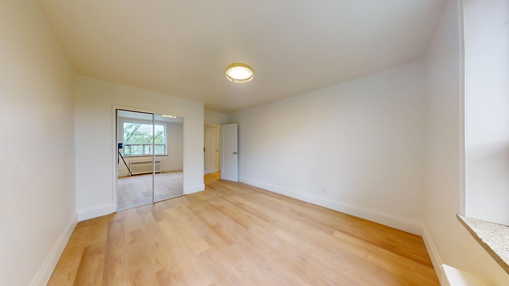 A room with wooden floors and white walls.