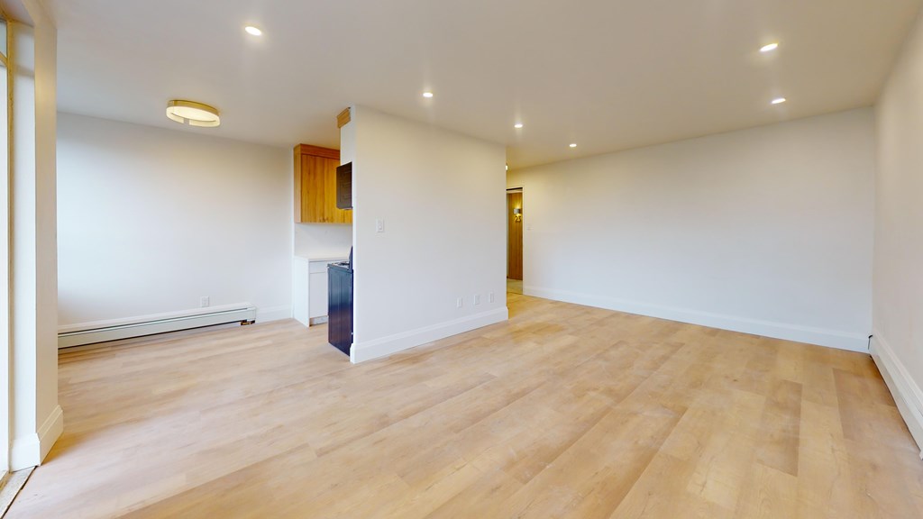 A room with wooden floors and white walls.