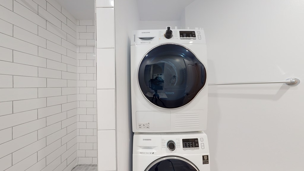 A white washing machine and dryer in a laundry room.