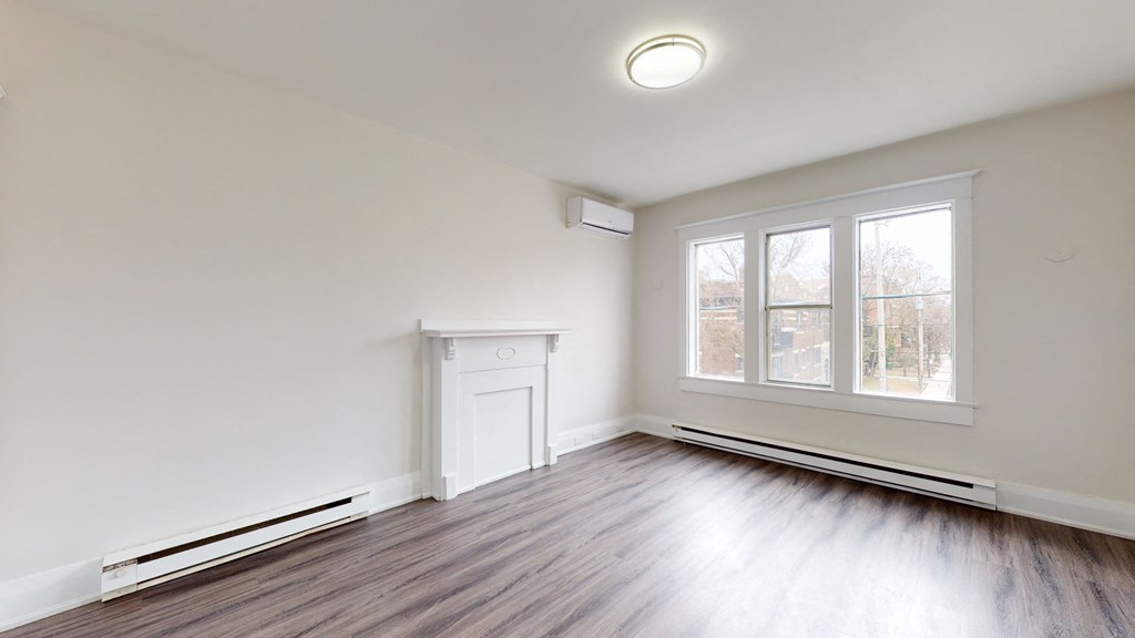 A room with a fireplace and a window.