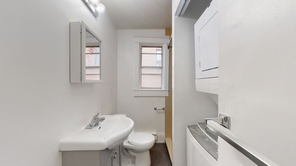 A white sink and toilet in a small bathroom.