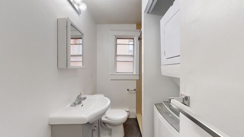 A white sink and toilet in a small bathroom.