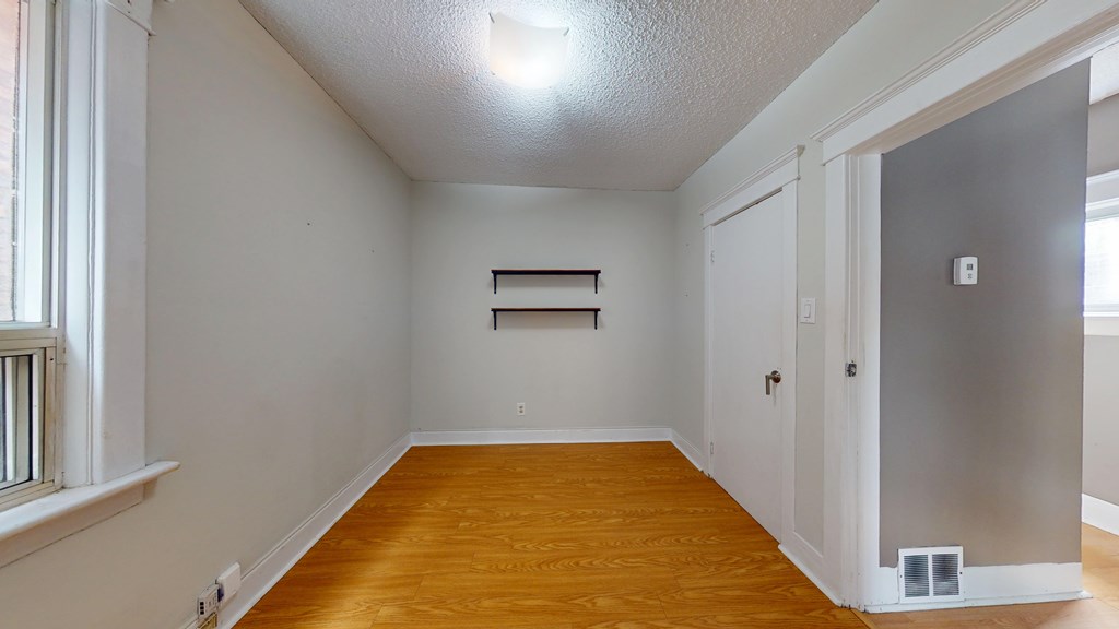 A room with wooden floors and white walls.