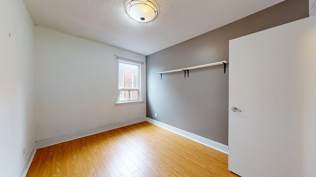 A room with a wooden floor and a window.