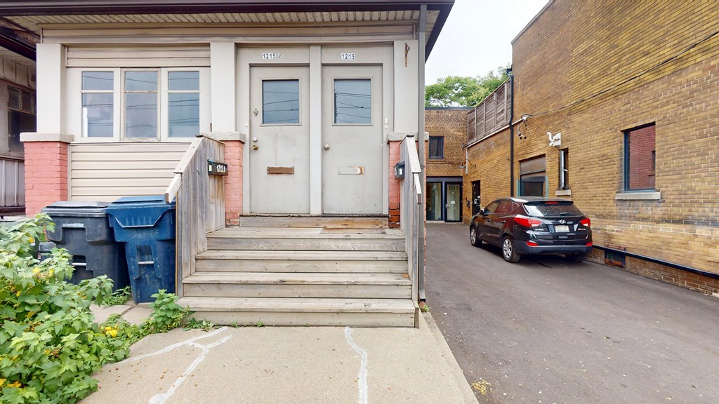 A house with a car parked in front of it.
