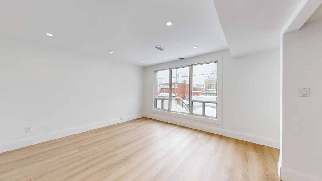 A room with a window overlooking a cityscape.