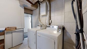A bathroom with a washer and dryer.