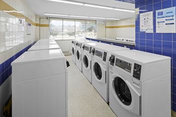 A row of washing machines in a laundromat.