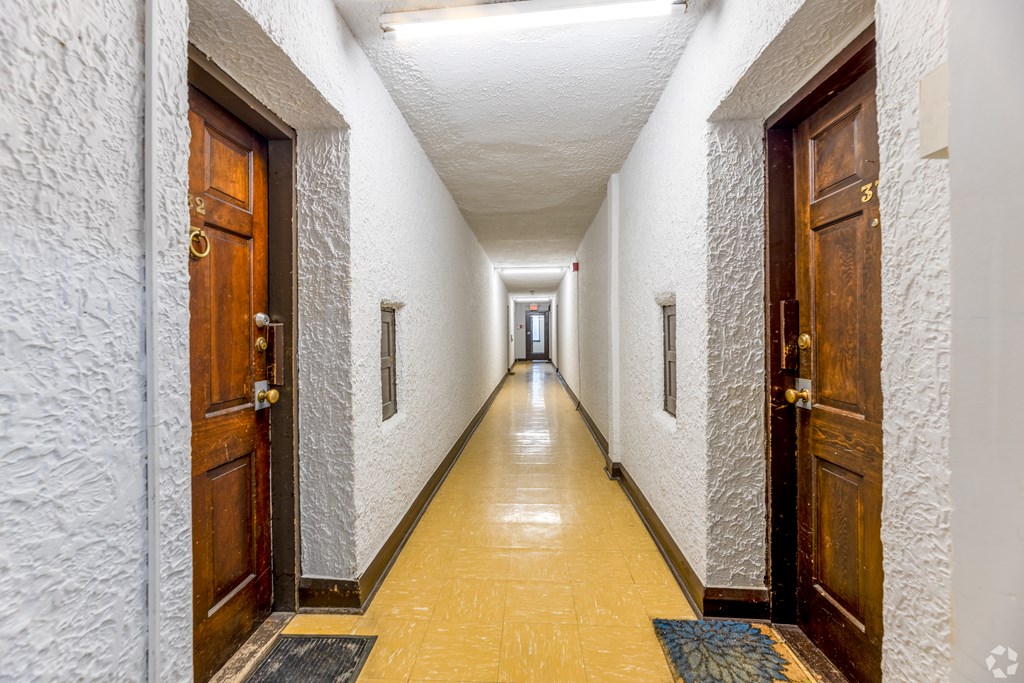 A long hallway with doors on both sides.
