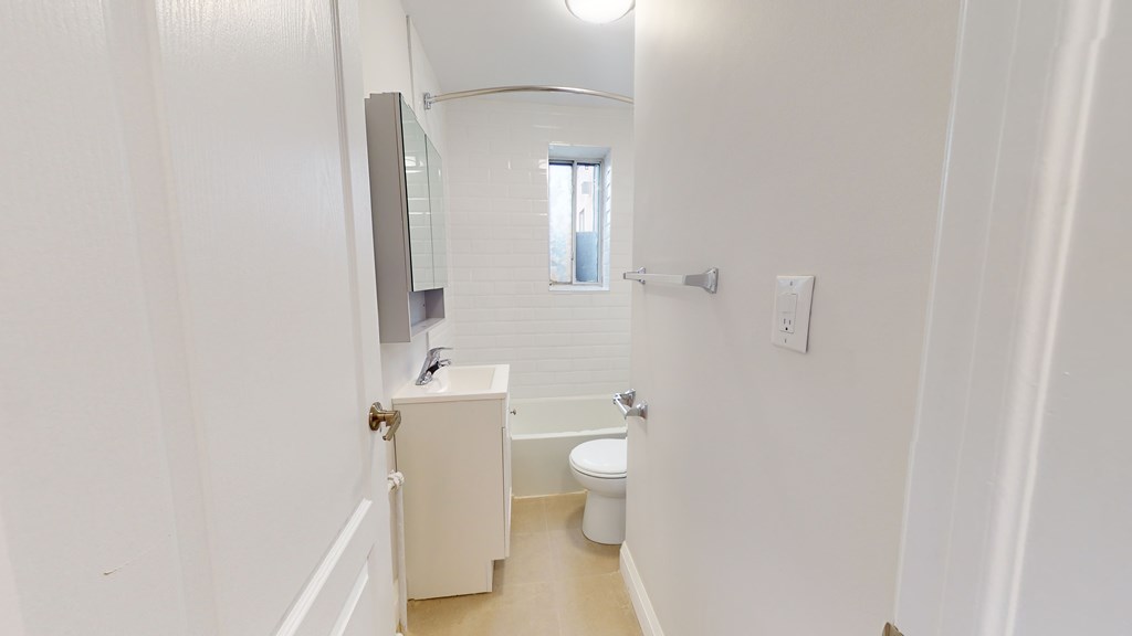 A white bathroom with a toilet and sink.