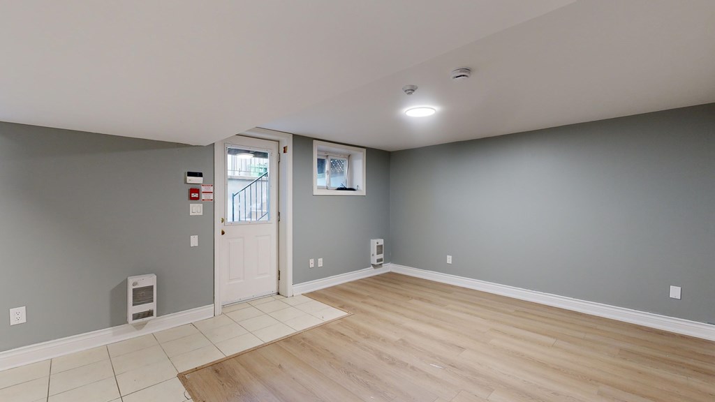 A room with a white door and a window.