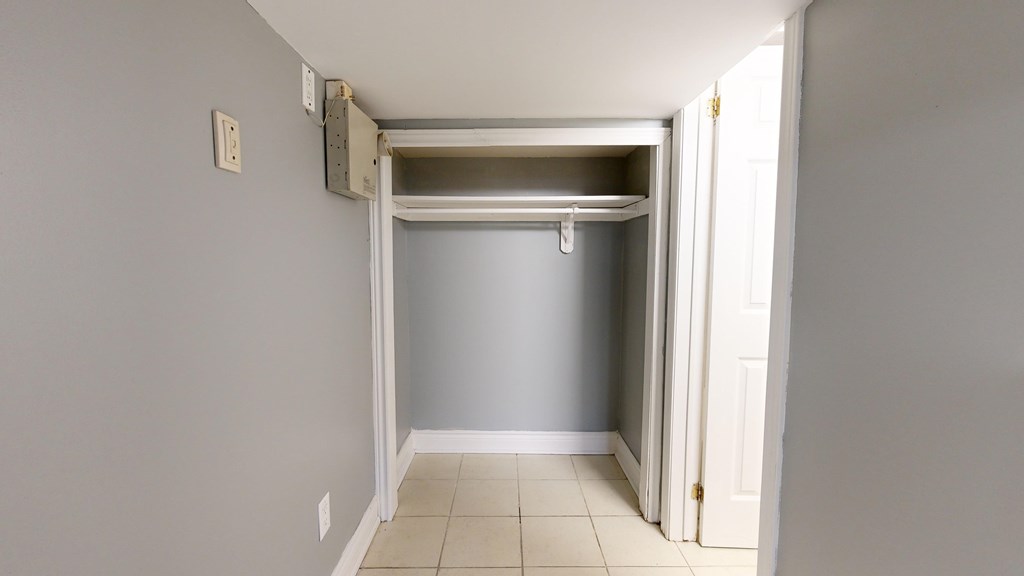 A room with a white door and a white wall.