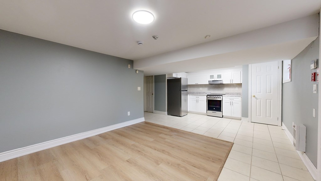 A kitchen area with a refrigerator, oven, and microwave.