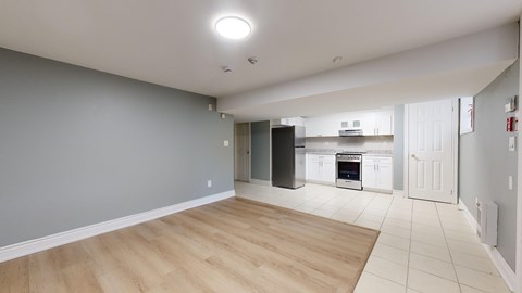 A kitchen area with a refrigerator, oven, and microwave.