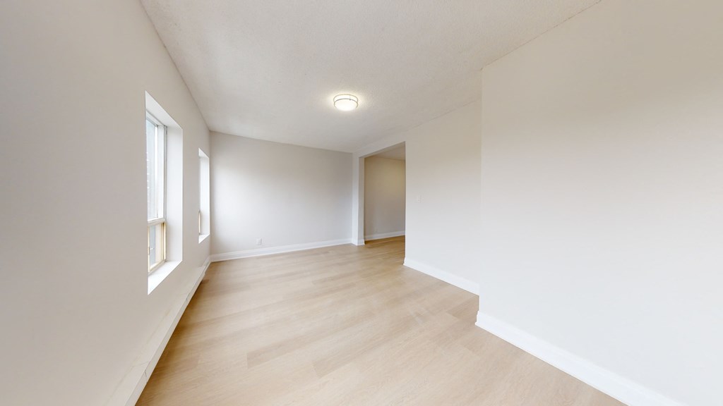 A room with wooden floors and white walls.