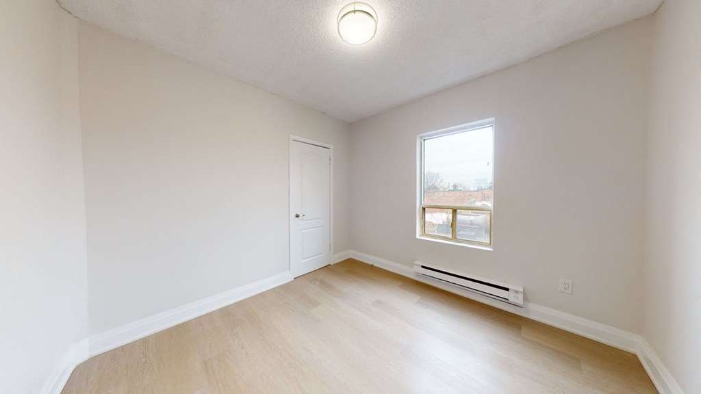 Empty room with a window and a door.