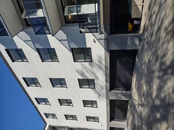 A tall building with many windows and balconies.
