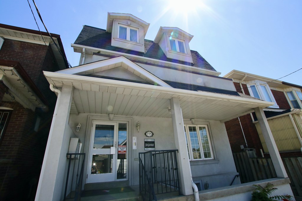 A house with a sunny sky above it.