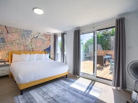 A bedroom with a large bed and a map on the wall.