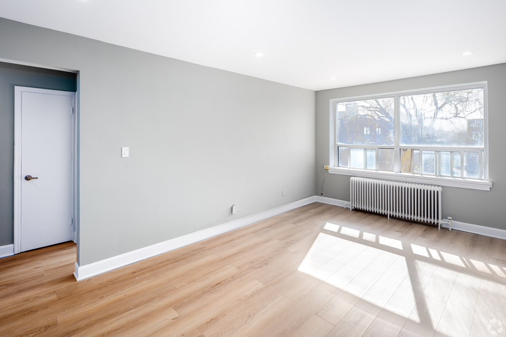 A room with wooden floors and a white door.