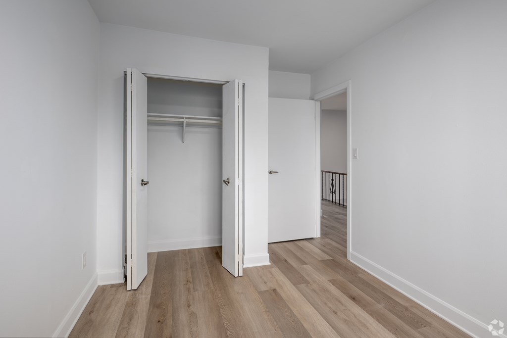 A room with a white door and a white wall.