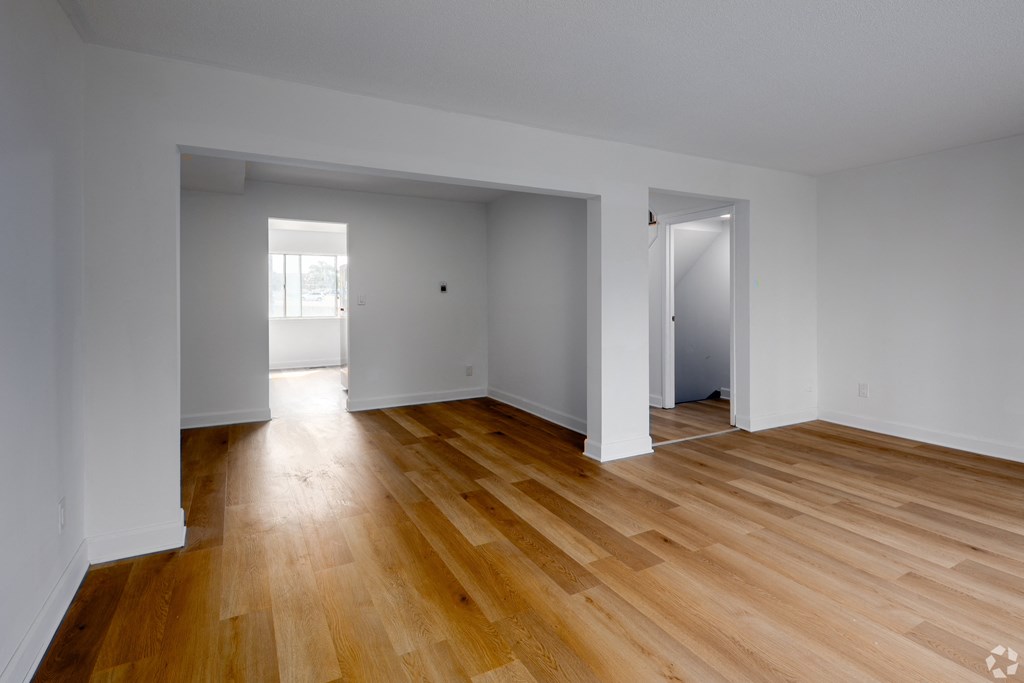 A room with wooden floors and white walls.