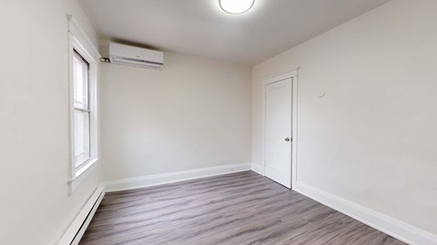 A room with a window and a door.